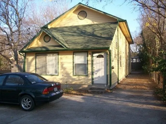 a front view of a house with parking area