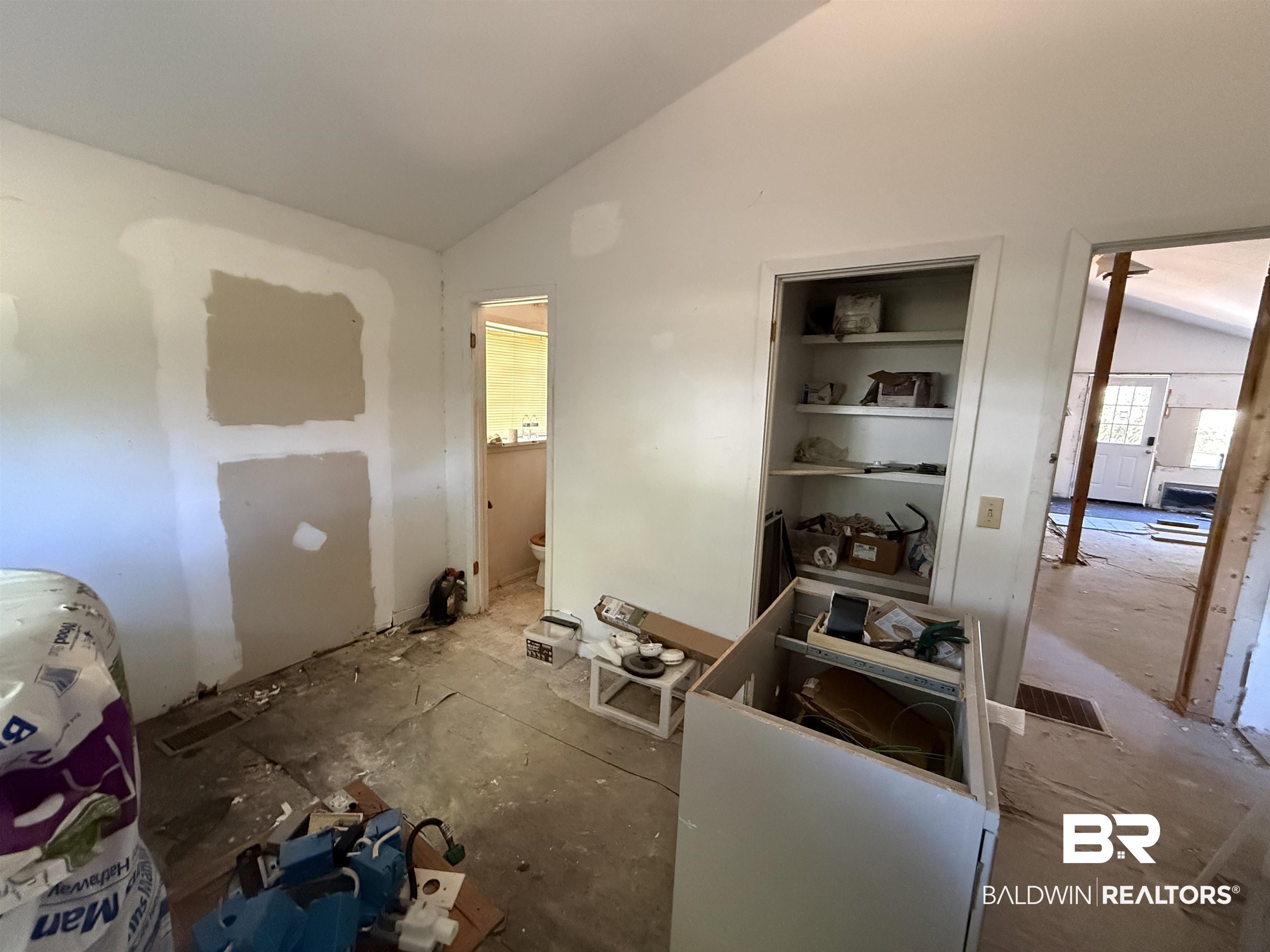 1276 Rio Circle Lillian, AL 36549 - Photo 2 of 7 Interior space under renovation featuring unfinished walls, exposed subflooring, and an open doorway