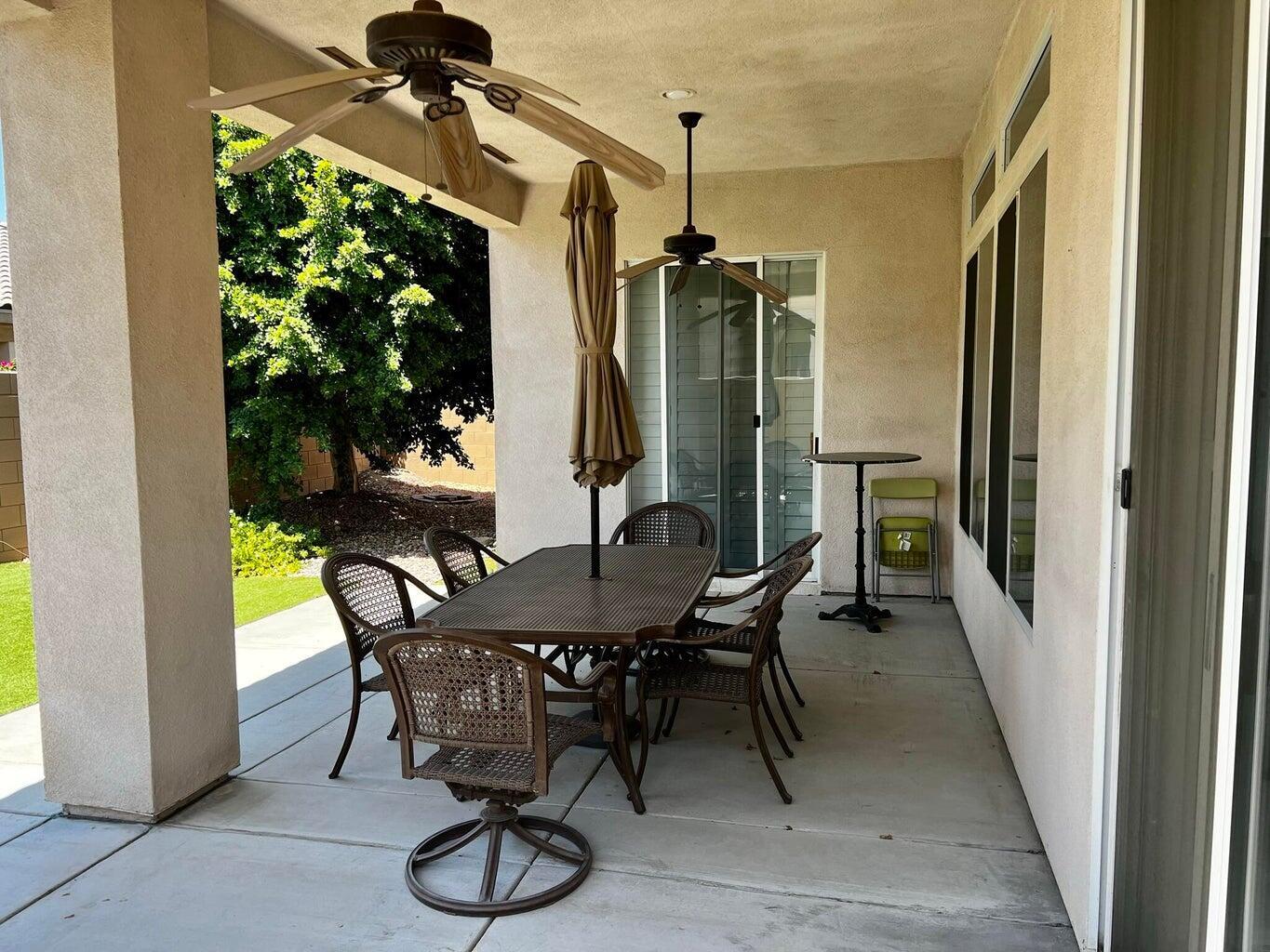 44725 Alexandria Vale Indio, CA 92201 - Photo 12 of 22 a view of an outdoor dining space with a table and chairs