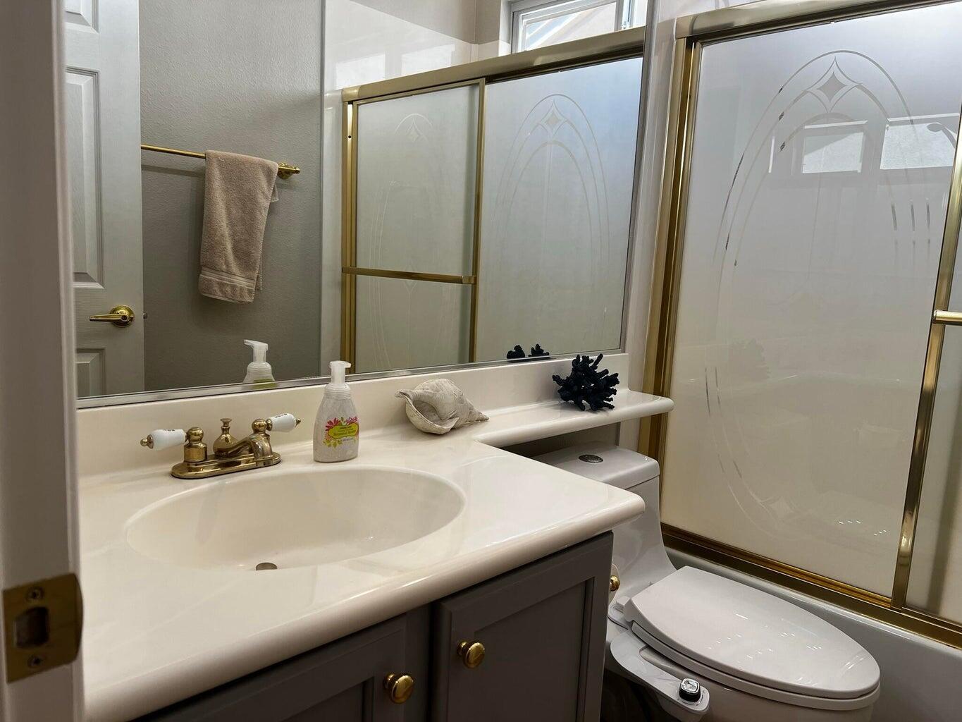 44725 Alexandria Vale Indio, CA 92201 - Photo 17 of 22 a bathroom with a sink a toilet a mirror and shower