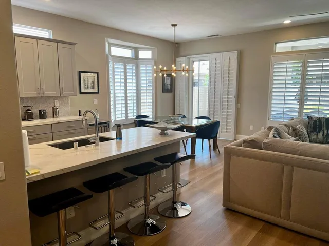 a kitchen with a table chairs stove and sink