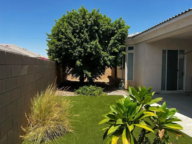 a view of a porch with a table and chairs