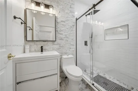 a bathroom with a sink toilet and shower