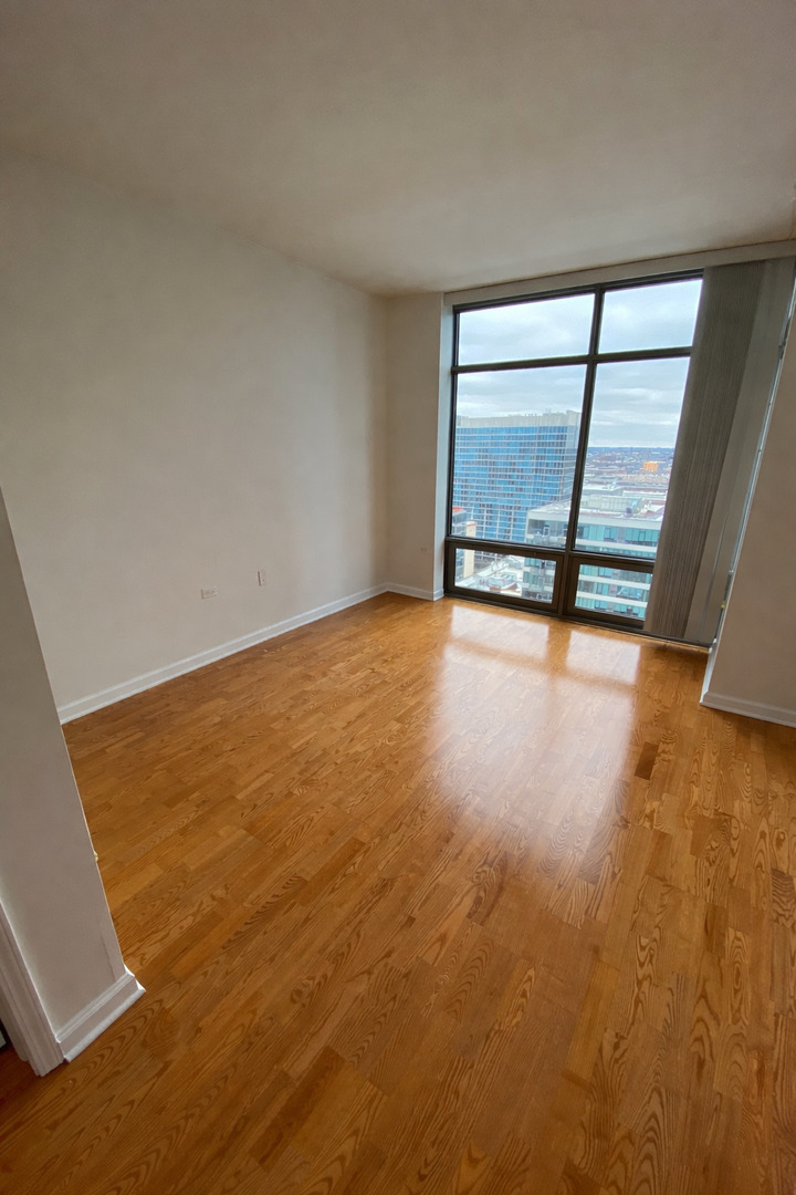 100 East 14th Street, Unit 2010 Chicago, IL 60605 - Photo 12 of 30 an empty room with a fireplace and sliding door