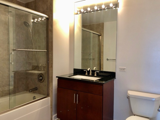 100 East 14th Street, Unit 2010 Chicago, IL 60605 - Photo 16 of 30 a bathroom with a sink and a mirror