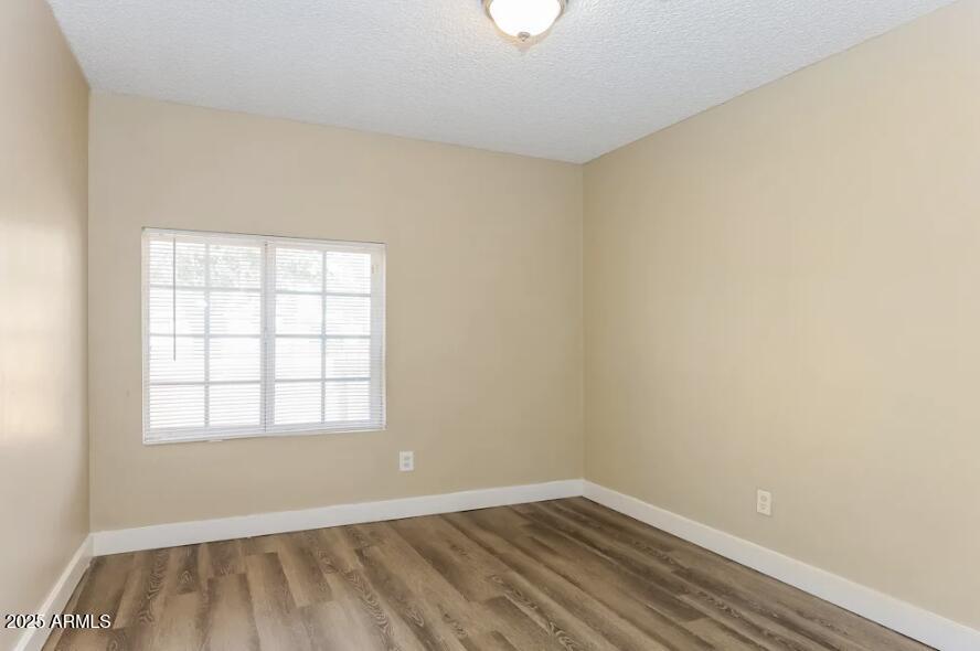 7129 West Merrell Street Phoenix, AZ 85033 - Photo 6 of 6 an empty room with a window