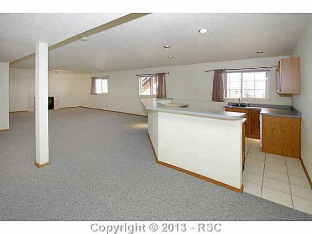 5905 Wilson Road Colorado Springs, CO 80919 - Photo 20 of 25 Garden Level Basement w/ Recreation Room, Gas Fireplace & Wet Bar