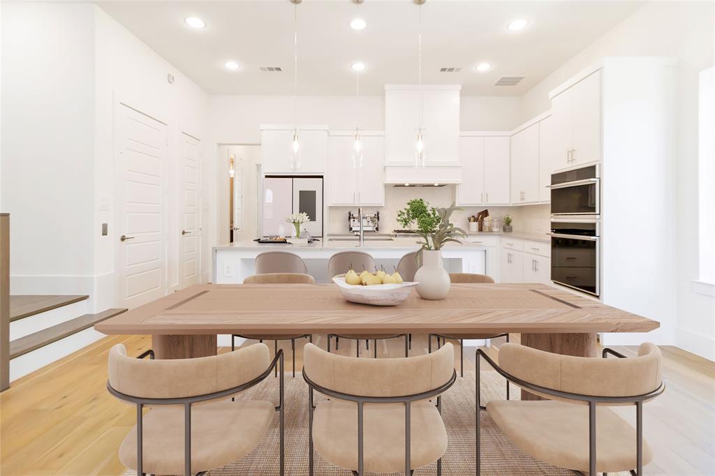 7844 Secluded Avenue Plano, TX 75024 - Photo 2 of 5 a kitchen with granite countertop kitchen island stainless steel appliances a table and chairs