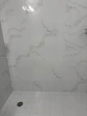a white toilet and shower in a bathroom