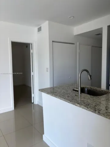 a kitchen with a sink and a mirror