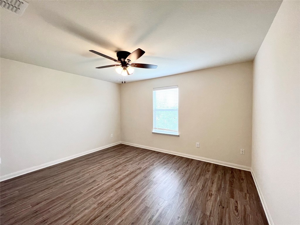 108 Major Lee Lane Jarrell, TX 76537 - Photo 12 of 15 an empty room with wooden floor and windows