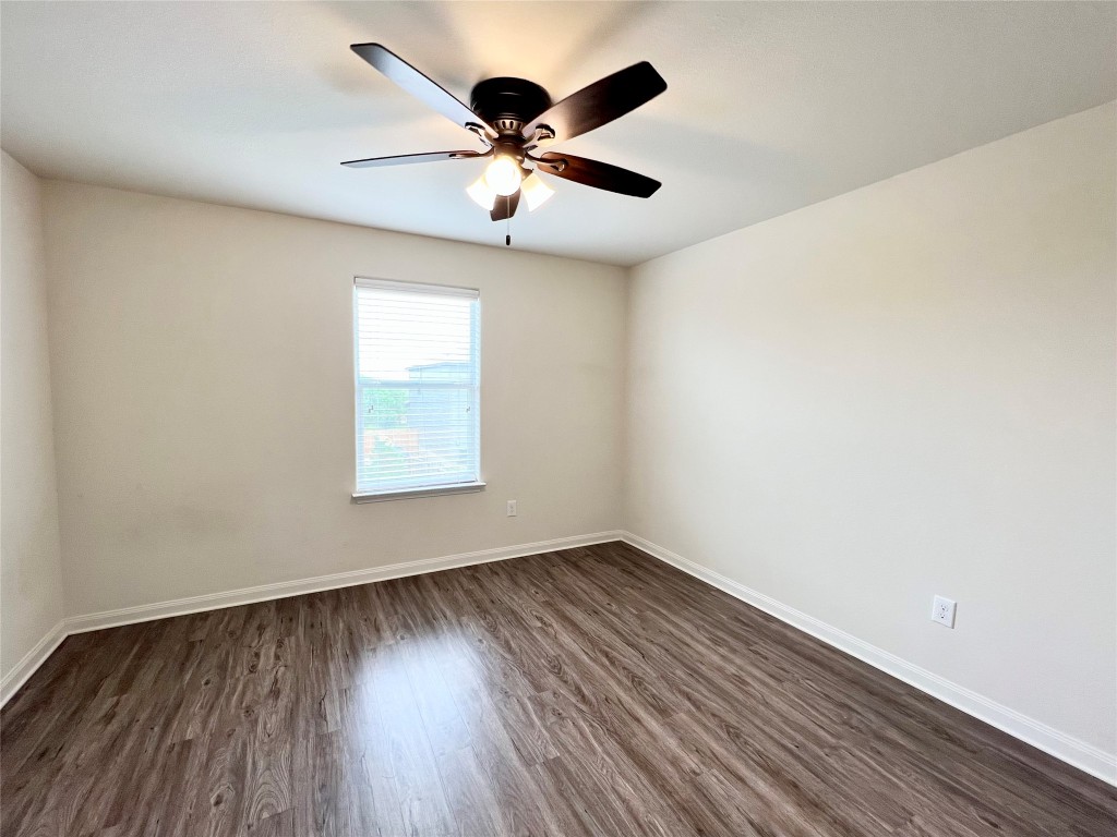 108 Major Lee Lane Jarrell, TX 76537 - Photo 14 of 15 an empty room with wooden floor ceiling fan and windows
