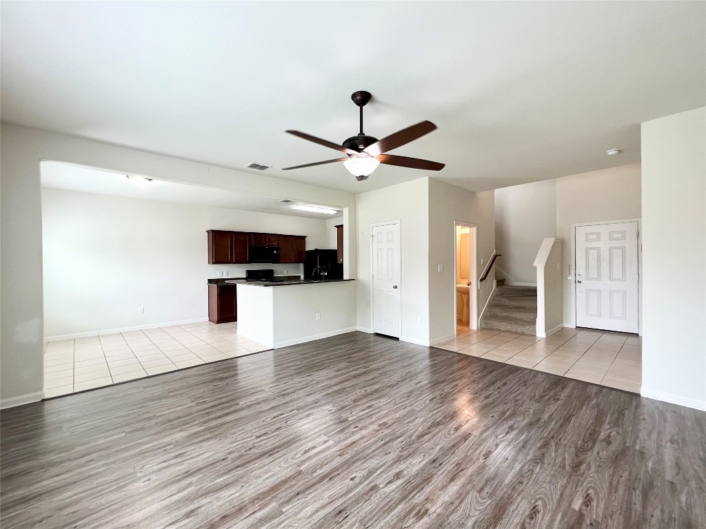 108 Major Lee Lane Jarrell, TX 76537 - Photo 5 of 15 a view of an empty room with wooden floor and a ceiling fan