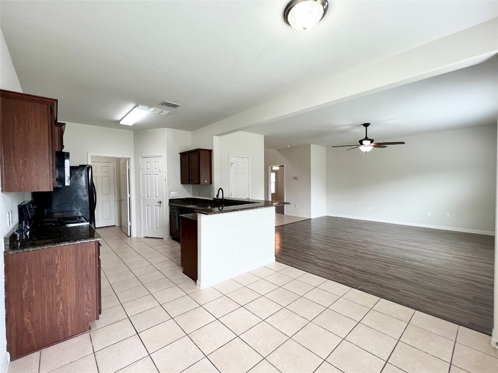 108 Major Lee Lane Jarrell, TX 76537 - Photo 6 of 15 a kitchen with stainless steel appliances a refrigerator sink and microwave