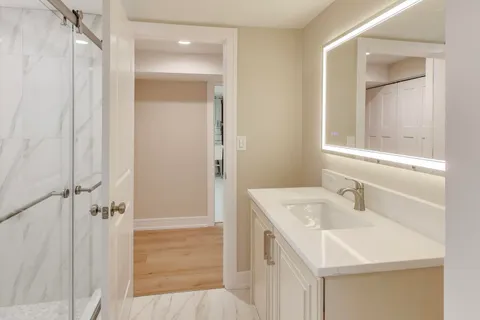 a bathroom with a sink a mirror and a shower