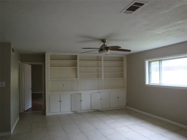 an empty room with a empty space and windows