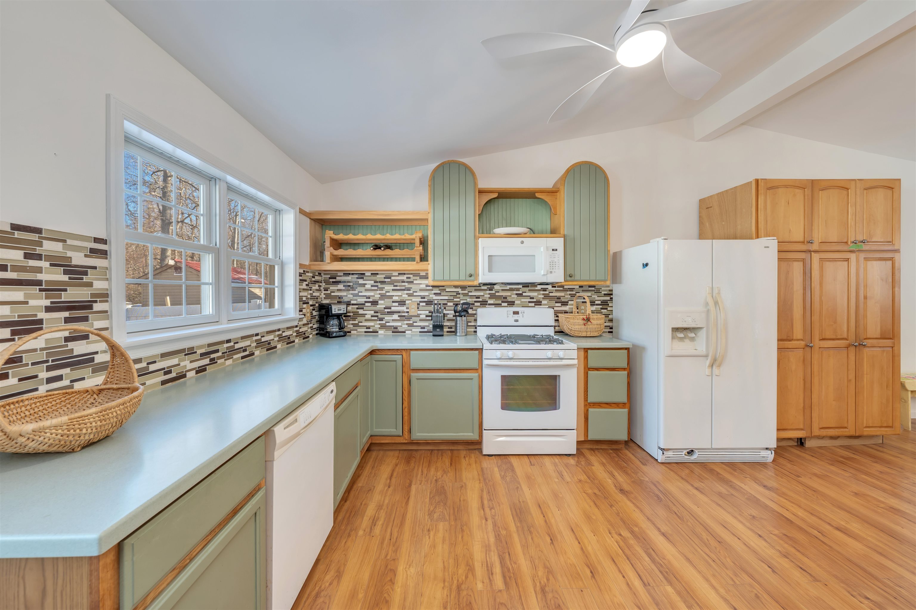 220 Iselin Road Cape May, NJ 08204 - Photo 11 of 43 a kitchen with stainless steel appliances a stove a sink cabinets and wooden floor