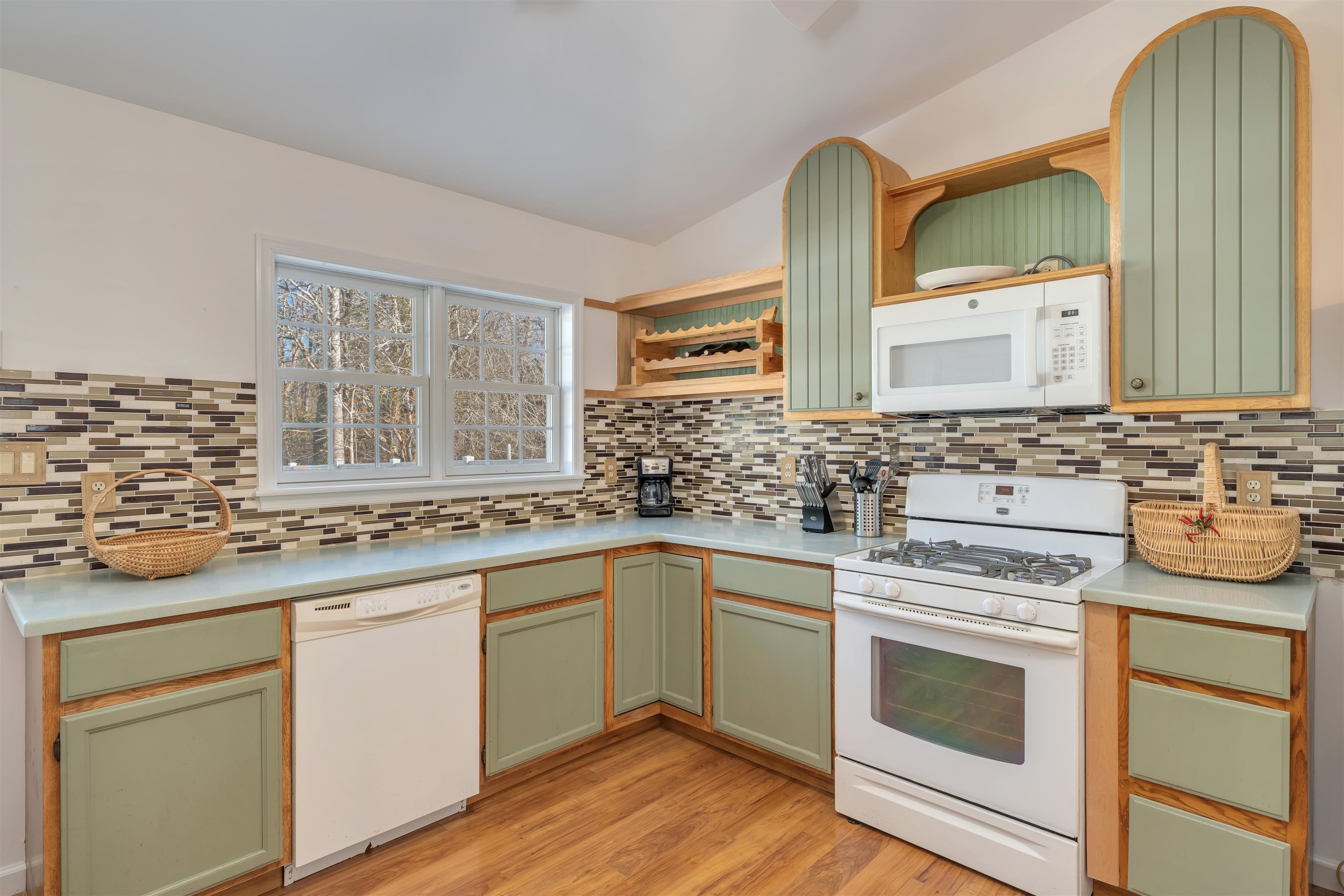 220 Iselin Road Cape May, NJ 08204 - Photo 12 of 43 a kitchen with stainless steel appliances granite countertop a sink and cabinets with wooden floor
