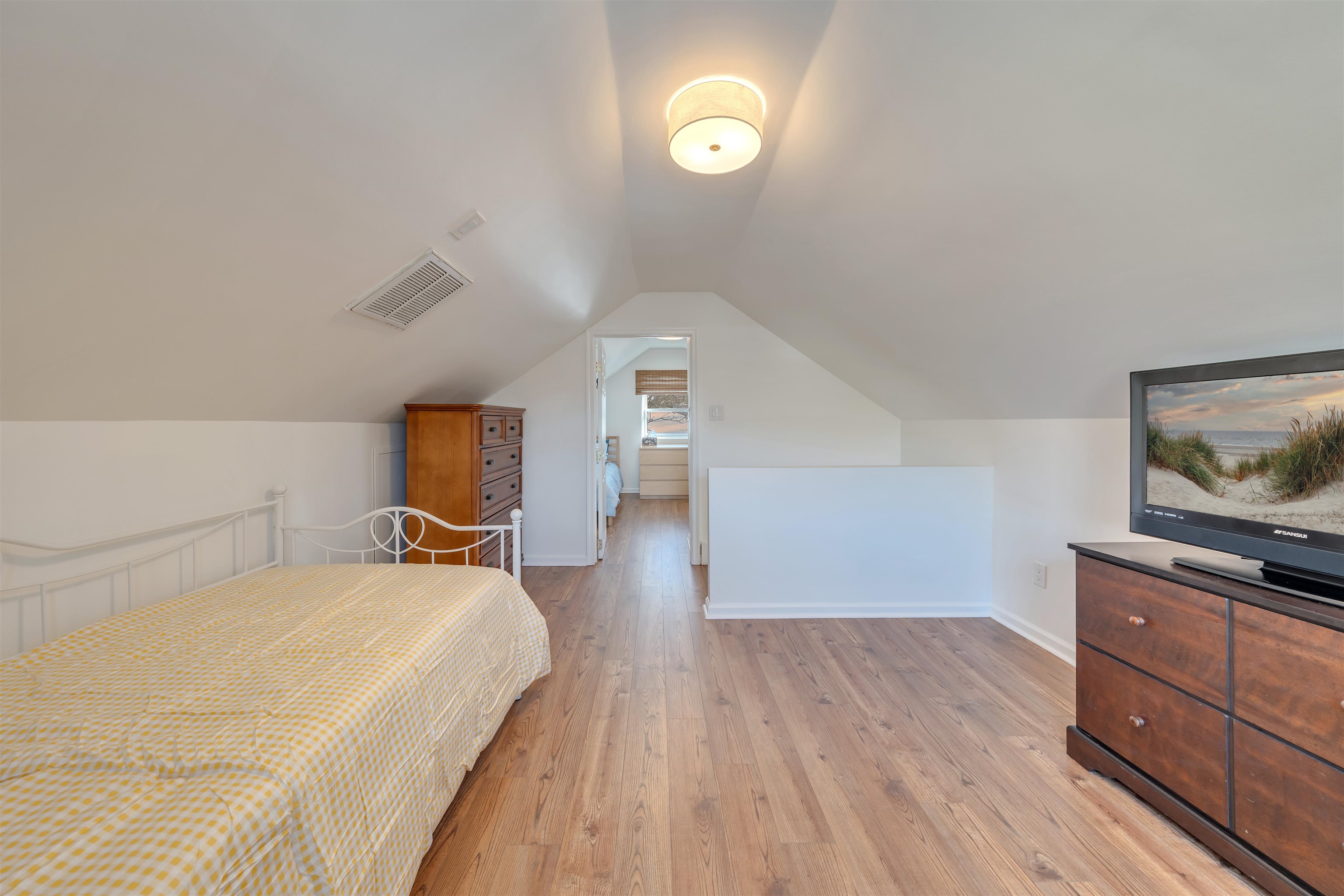 220 Iselin Road Cape May, NJ 08204 - Photo 29 of 43 a bedroom with a bed and wooden floor