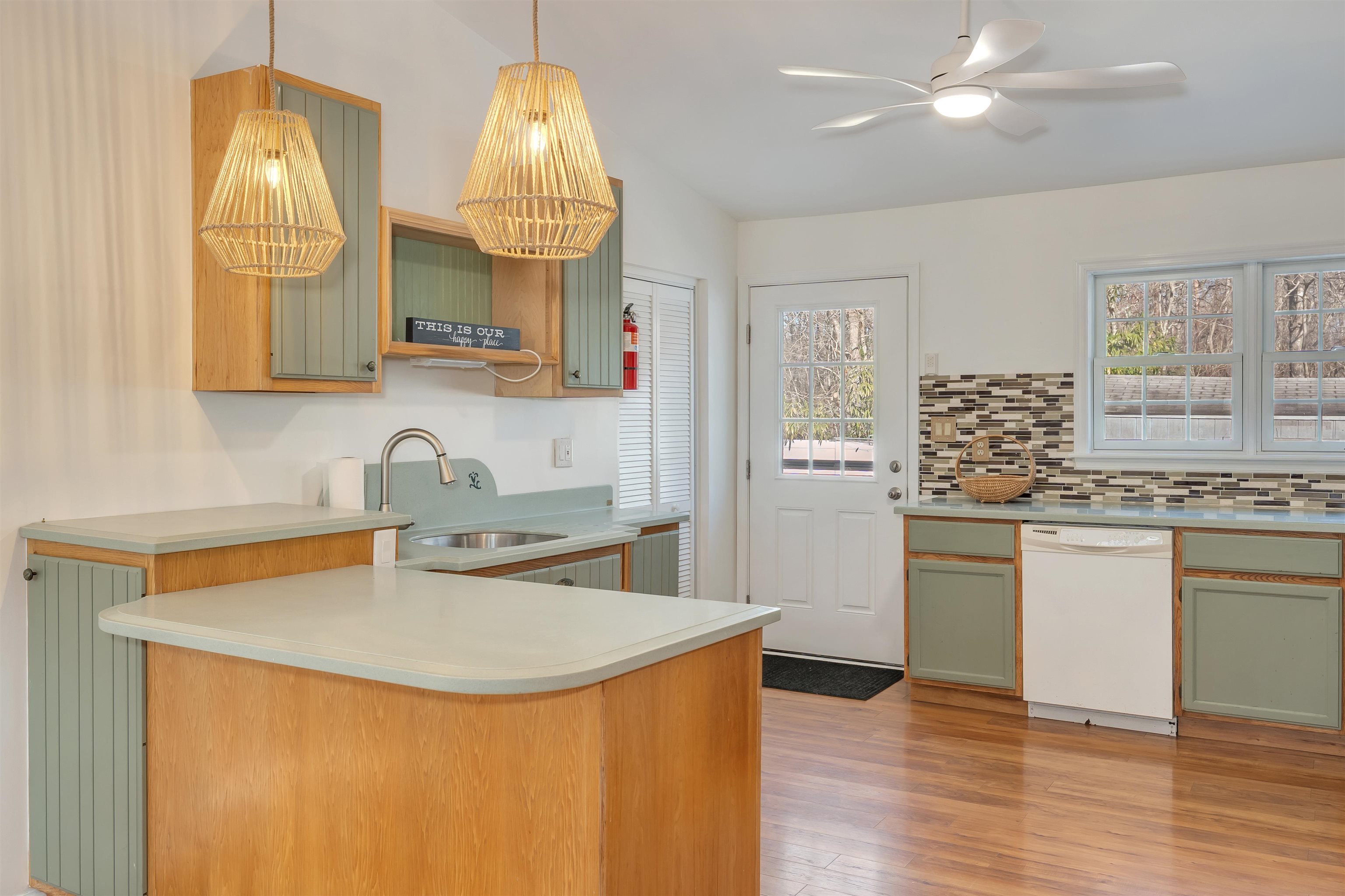 220 Iselin Road Cape May, NJ 08204 - Photo 7 of 43 a kitchen with stainless steel appliances granite countertop a sink dishwasher and white cabinets with wooden floor