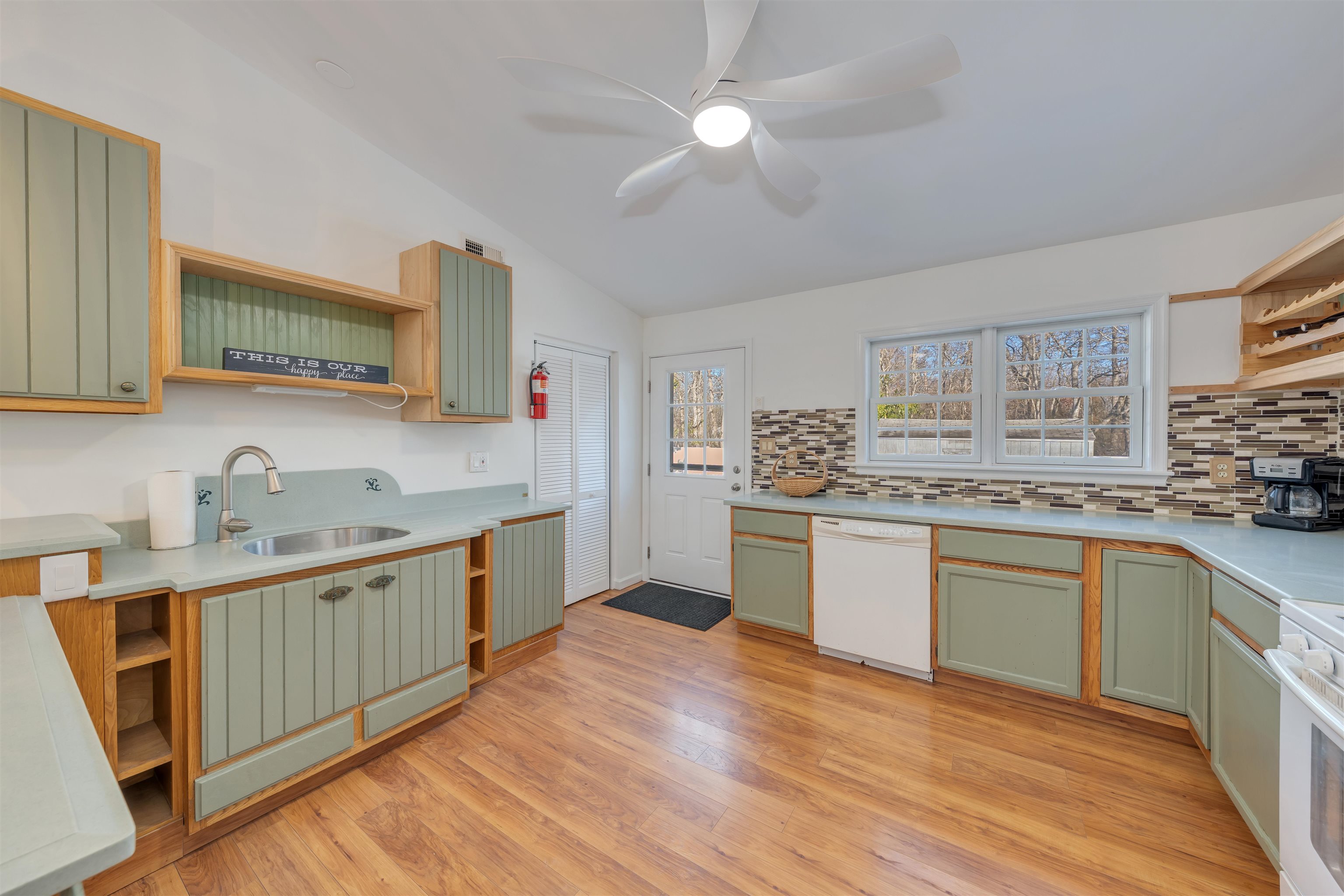 220 Iselin Road Cape May, NJ 08204 - Photo 8 of 43 a kitchen with granite countertop a sink cabinets stainless steel appliances and a window