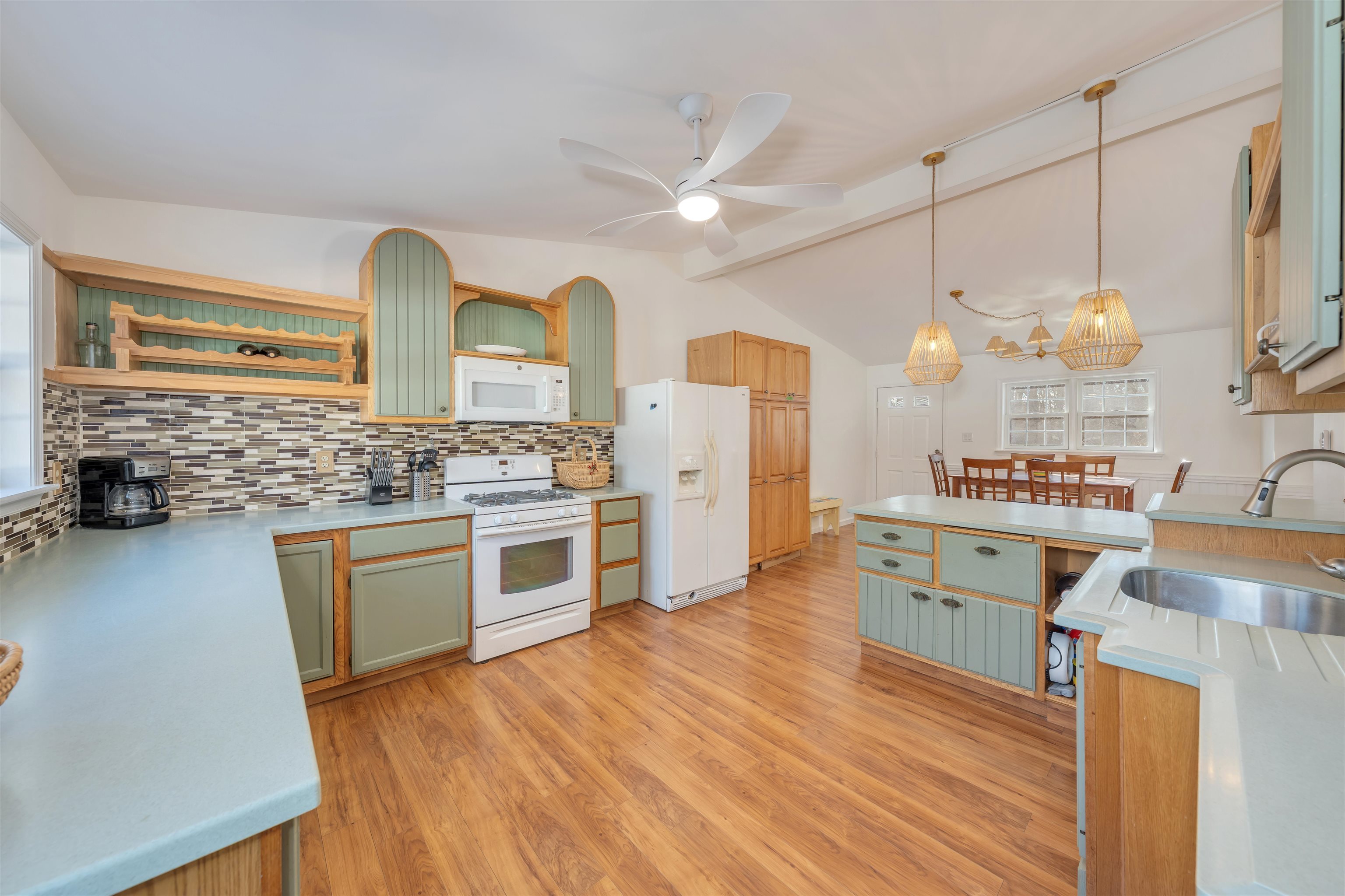 220 Iselin Road Cape May, NJ 08204 - Photo 10 of 43 a kitchen with stainless steel appliances kitchen island granite countertop a stove a sink dishwasher and a refrigerator with wooden floor