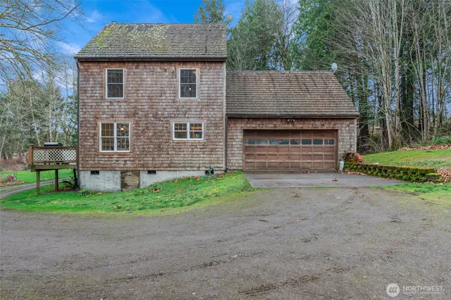 a front view of a house with a garden and yard