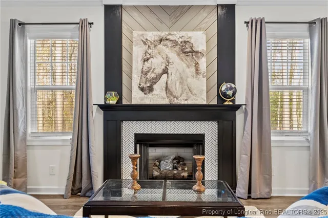 a living room with a fireplace and a window
