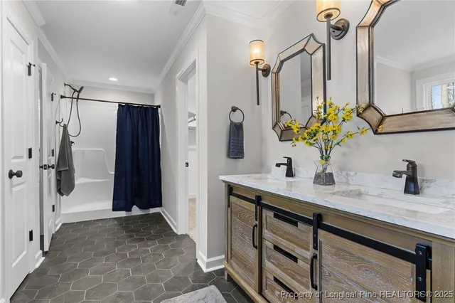 a bathroom with a granite countertop sink a mirror a vanity and a shower