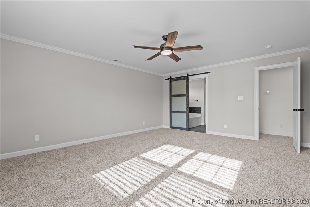 296 Persimmon Tree Drive Cameron, NC 28326 - Photo 19 of 43 a view of empty room with wooden floor and ceiling fan
