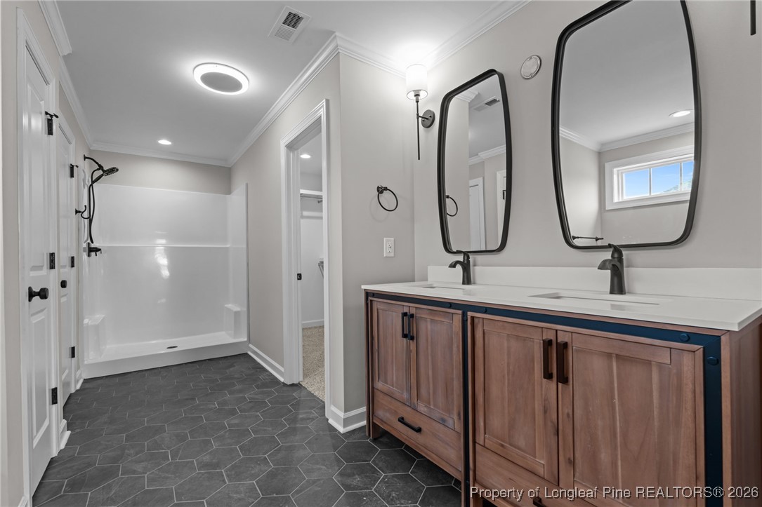 296 Persimmon Tree Drive Cameron, NC 28326 - Photo 21 of 43 a bathroom with double vanity sinks and a mirror
