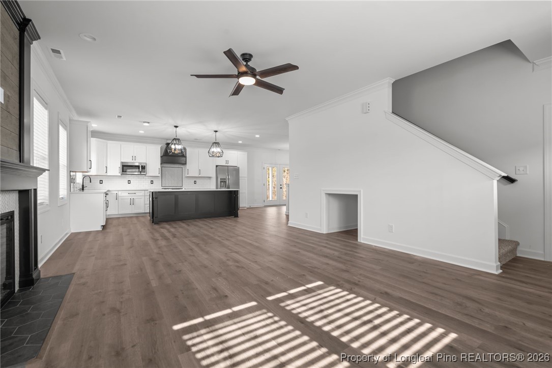 296 Persimmon Tree Drive Cameron, NC 28326 - Photo 3 of 43 a living room with stainless steel appliances kitchen island hardwood floor and a kitchen view