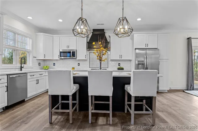 a view of kitchen and dining area with furniture wooden floor