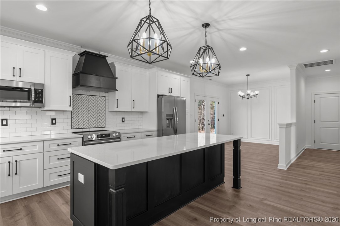 296 Persimmon Tree Drive Cameron, NC 28326 - Photo 6 of 43 a kitchen with kitchen island granite countertop a sink a stove a refrigerator and cabinets