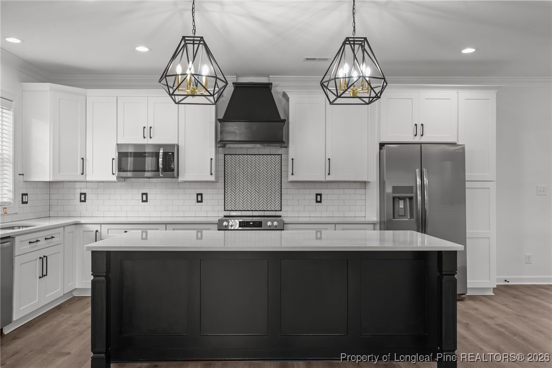 296 Persimmon Tree Drive Cameron, NC 28326 - Photo 7 of 43 a kitchen with stainless steel appliances granite countertop a sink a microwave oven and a refrigerator
