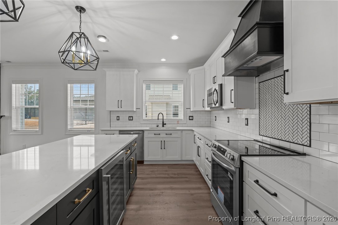 296 Persimmon Tree Drive Cameron, NC 28326 - Photo 8 of 43 a kitchen with kitchen island granite countertop stainless steel appliances sink stove top oven and cabinets