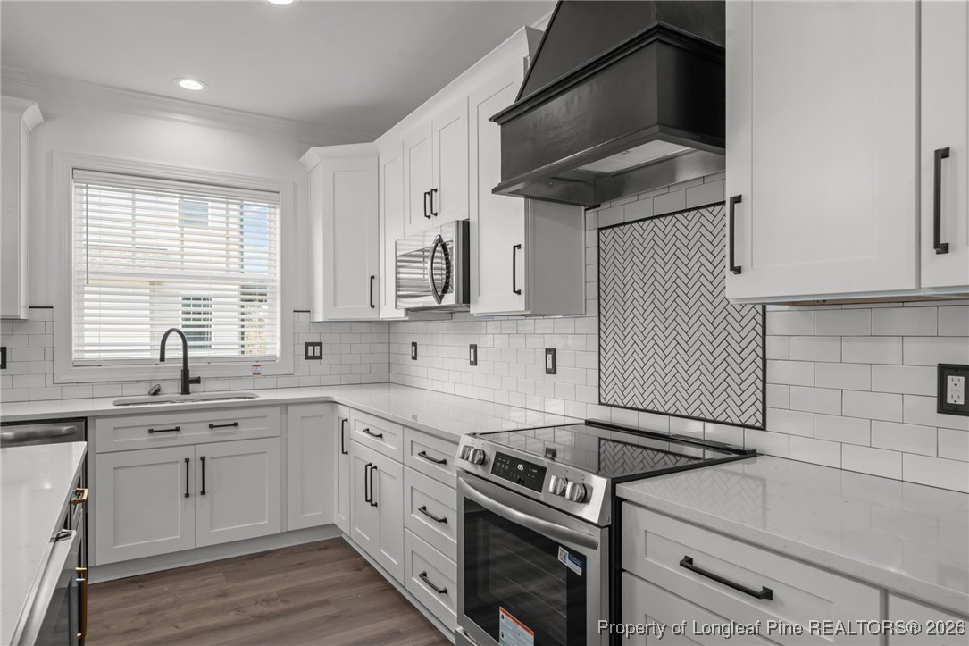 296 Persimmon Tree Drive Cameron, NC 28326 - Photo 9 of 43 a kitchen with cabinets stainless steel appliances and a sink