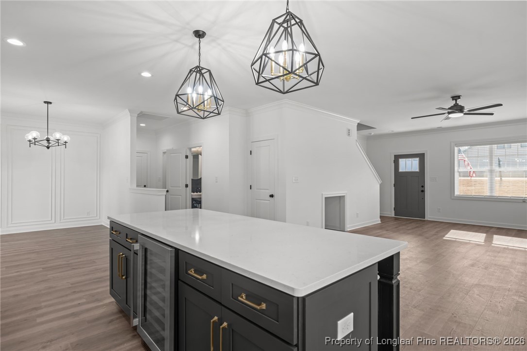 296 Persimmon Tree Drive Cameron, NC 28326 - Photo 10 of 43 a kitchen with a sink chandelier and wooden floor