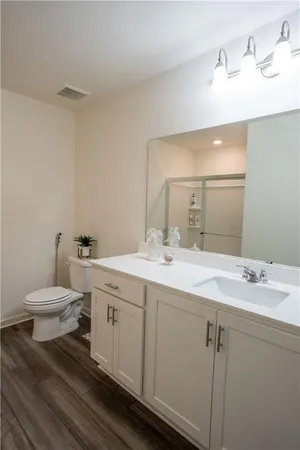 a bathroom with a toilet sink and mirror