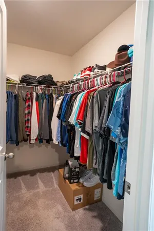 a view of walk in closet with clothes