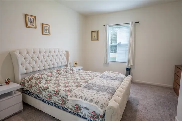 a bed sitting in a bedroom next to a window