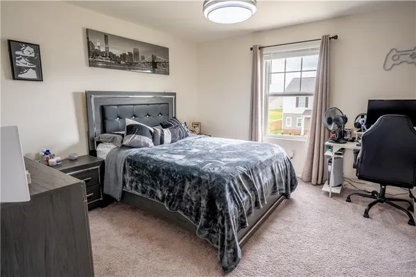 a bedroom with a bed chair and window