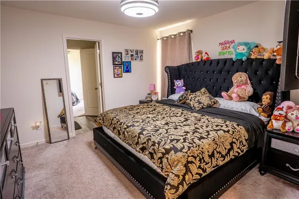 a bedroom with a bed and a baby crib