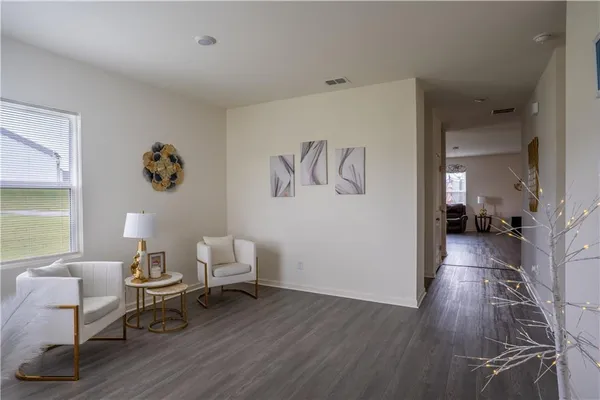 a living room with furniture and a wooden floor