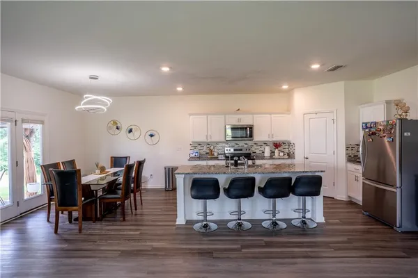 a view of a kitchen with dining table and chairs