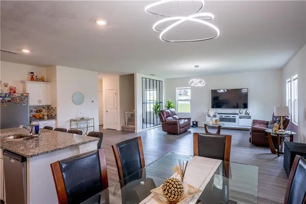 a living room with fireplace furniture and a flat screen tv