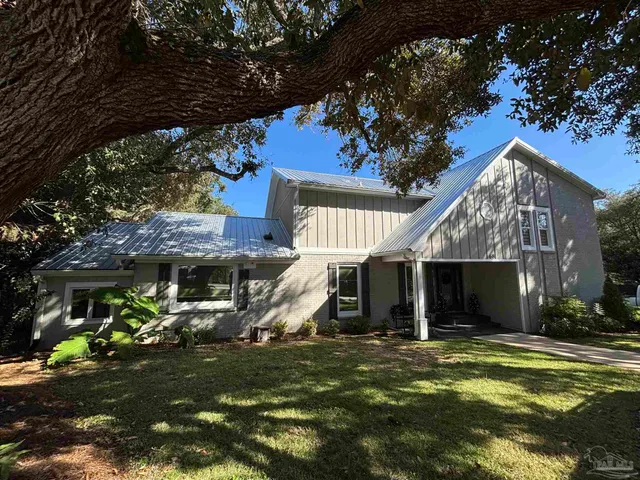 a view of a house with a yard porch and sitting area