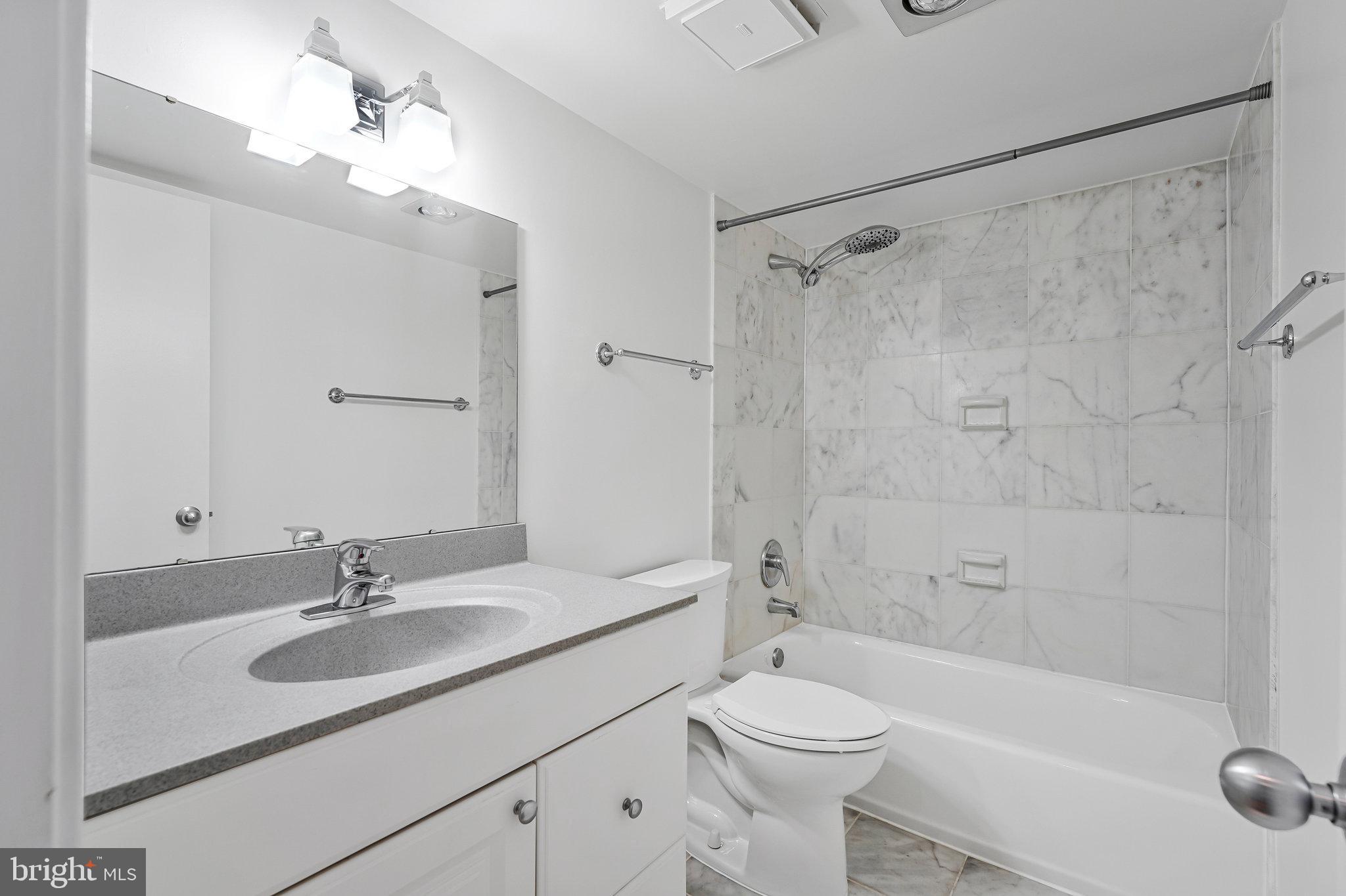 1800 Old Meadow Road, Unit 302 McLean, VA 22102 - Photo 15 of 35 a bathroom with a sink a toilet and shower