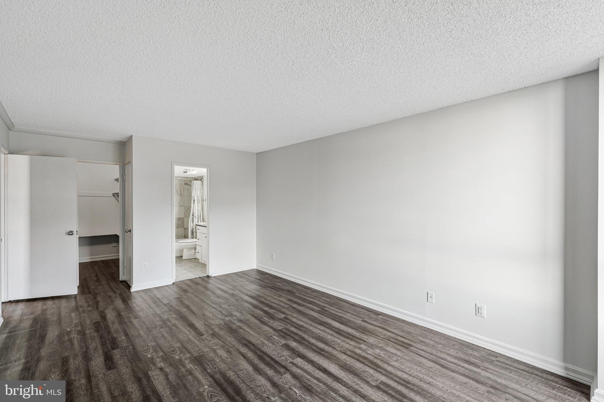 1800 Old Meadow Road, Unit 302 McLean, VA 22102 - Photo 17 of 35 a view of empty room with wooden floor and cabinets