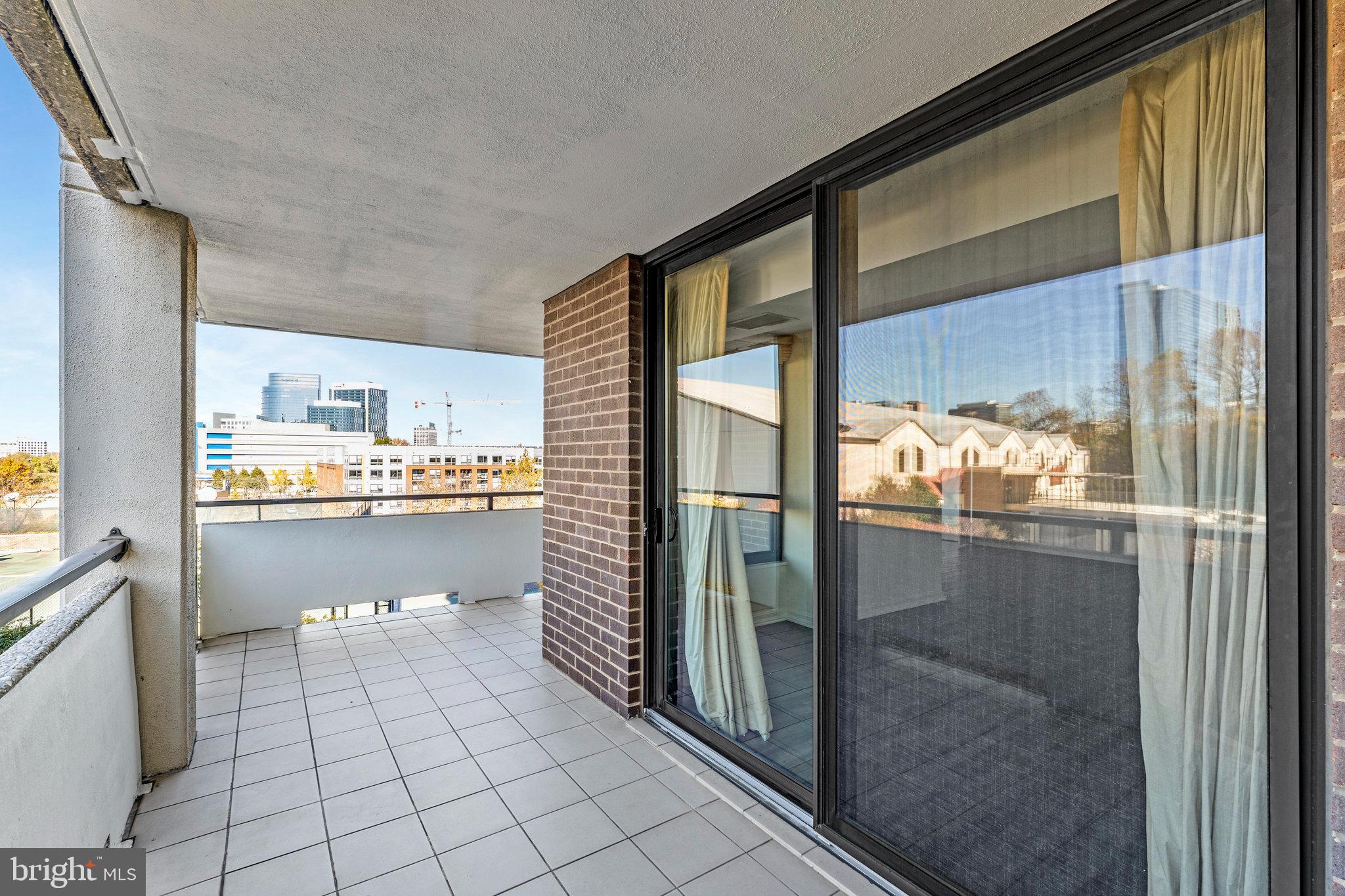 1800 Old Meadow Road, Unit 302 McLean, VA 22102 - Photo 20 of 35 a kitchen with white cabinets and a glass door shower